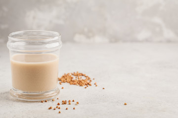 Homemade buckwheat milk in glass. Healthy vegan dairy-free alternative.