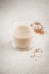 Homemade buckwheat milk in glass. Healthy vegan dairy-free alternative.