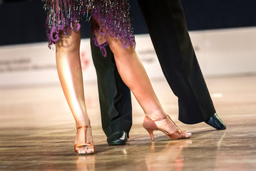 Legs of young dancers on the dance floor