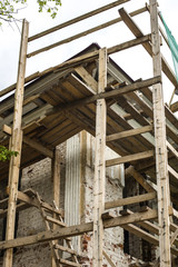 Fototapeta na wymiar Wooden scaffolding around the ancient building