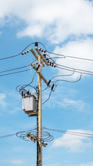 Electric pole and transformer on a blue sky.