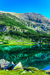 Naklejka na ściany i meble Amazing alpine lake in the high mountains. Beautiful fiord mountain, river, hiking scenic landscape, summertime.