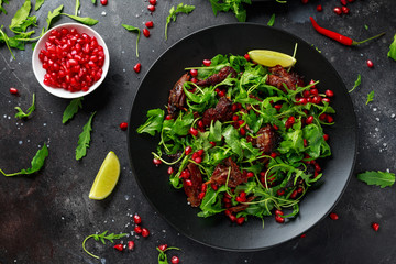 Spicy crispy duck salad with pomegranate seeds, lime and wild green rucola