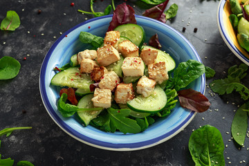 Fried Tofu Salad with Cucumbers, Sesame Seeds and green vegetables
