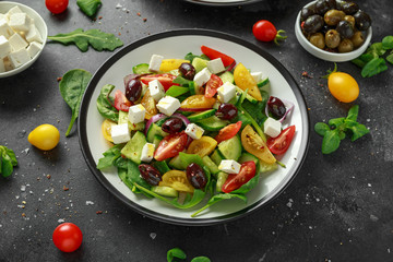 Fresh Greek salad with cucumber, cherry tomato, lettuce, red onion, feta cheese and black olives. Healthy food