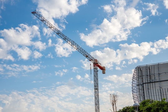 image of construction crane with cloudy sky background