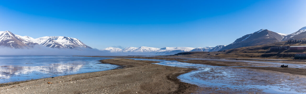 Panorama of Adventdalen surrounded by snowy mountains