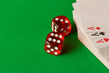 Dice and playing cards on the green table . Game concept. Games of chance