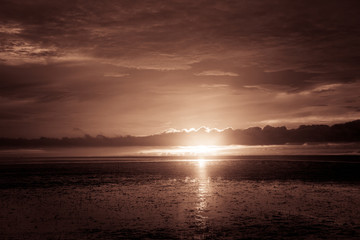 Wonderful dark silver and orange sea with sunset twilight sky in the evening time. scenery moment. spirit of serene and zen. image for background, wallpaper, interior, decorate and copy space. 