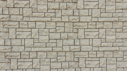 Textured wall made of bricks of different sizes.