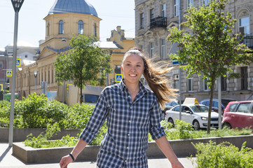 girl in plaid shirt with long hair in the tail in the city, girl in the city among the buildings, young woman, portrait, St. Petersburg