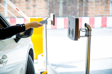 Hand held card to the scanner to open the car park door. security system for parking. image for background, wallpaper and copy space.