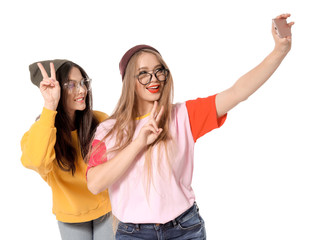 Attractive young women taking selfie on white background