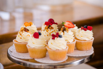Candy bar with sweet cakes and decor items in bright colors.