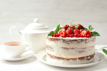 Delicious homemade cake with fresh berries served on wooden table