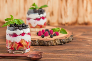 Trifle close up photography with fresh multi layered dessert with dairy and ripe raspberries and...