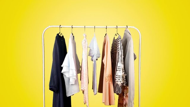 Clothes on a hanger on different colored backgrounds.