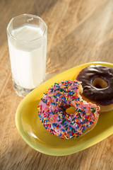 Delicious donuts with cup of milk