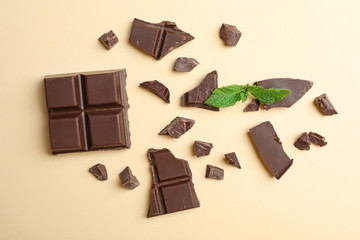 Flat lay composition with chocolate and mint on color background