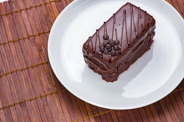 Chocolate cake on white plate