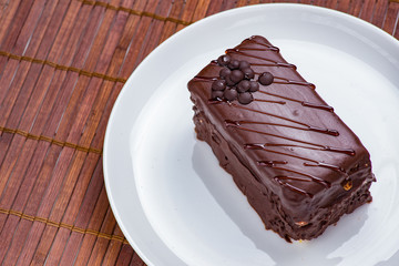 Chocolate cake on white plate