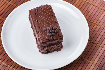 Chocolate cake on white plate