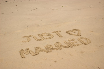 Just married written in the sand