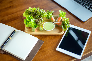 Salad Rolls in the workplace near laptop and notebook. Lunch in the office during a break between work.