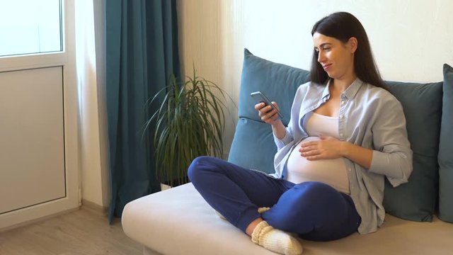 pregnant woman stroking her belly