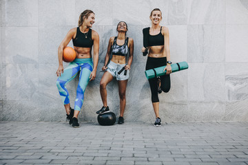 Women in fitness wear standing on street after workout