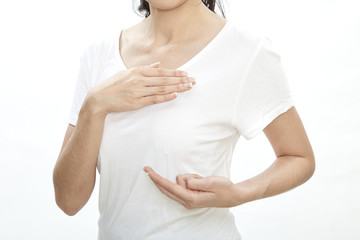 Woman examining herself for breast cancer