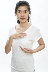 Woman examining herself for breast cancer