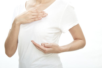 Woman examining herself for breast cancer