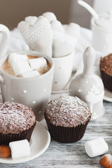 Chocolate cupcakes, marshmallow and different Christmas decorations