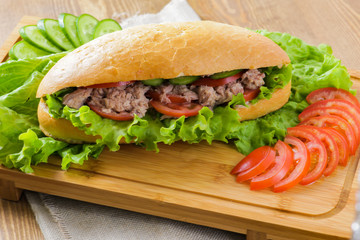 Tuna sandwich on wooden background