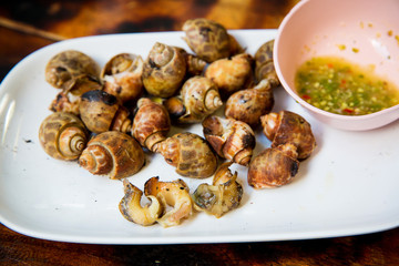 Spotted babylon roasted with spicy and sour sauce thai style. Thai recommend menu for tourist. The famous thai street seafood. Asian local seafood in many asia-china countries.