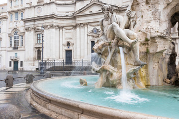 Fountain of the Four Rivers in the Piazza Navona (Navona Square) in Rome with Sant'Agnese in Agone church in the background. Italy