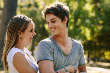 Smiling couple having fun in a park