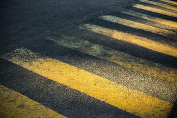 Yellow crosswalk sign on asphalt