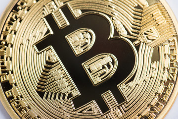 Golden bitcoin isolated on white