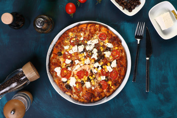 pizza with olive and cheese with olive oil on a wooden background