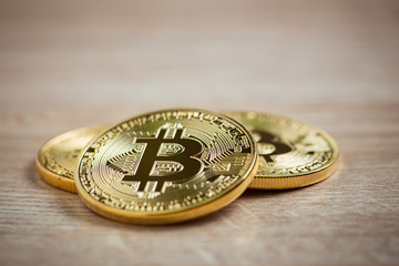 Golden bitcoins on wooden background