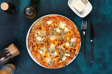 cheese pizza with pepper and olive oil on a wooden background
