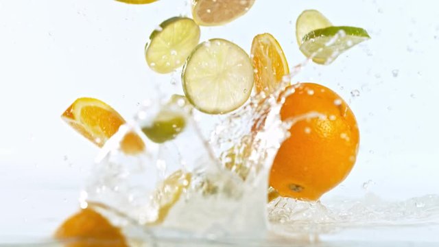 Fresh citruses dropped into water with splash, shooted with high speed cinema camera at 1000 fps. 4K footage.