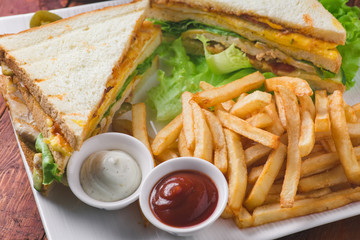 Club sandwich served with french fries and soda