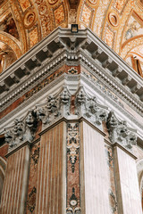 Church in Naples, frescoes and stucco work inside. Beautiful decoration and historical vaults. Symmetry and paintings under the dome. The organ is gilded, the altar, and the icons on the walls.