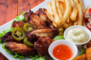 Big and tasty combo of nuggets, french fries, fried chicken legs and canape