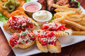 Big and tasty combo of nuggets, french fries, fried chicken legs and canape