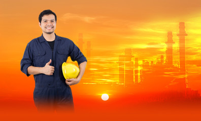 Male technician on an orange background with an industrial shadow at sunset.