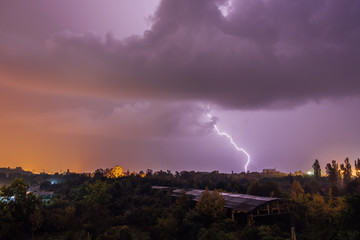 Fototapeta premium Lightning strikes during thunderstorm over the city